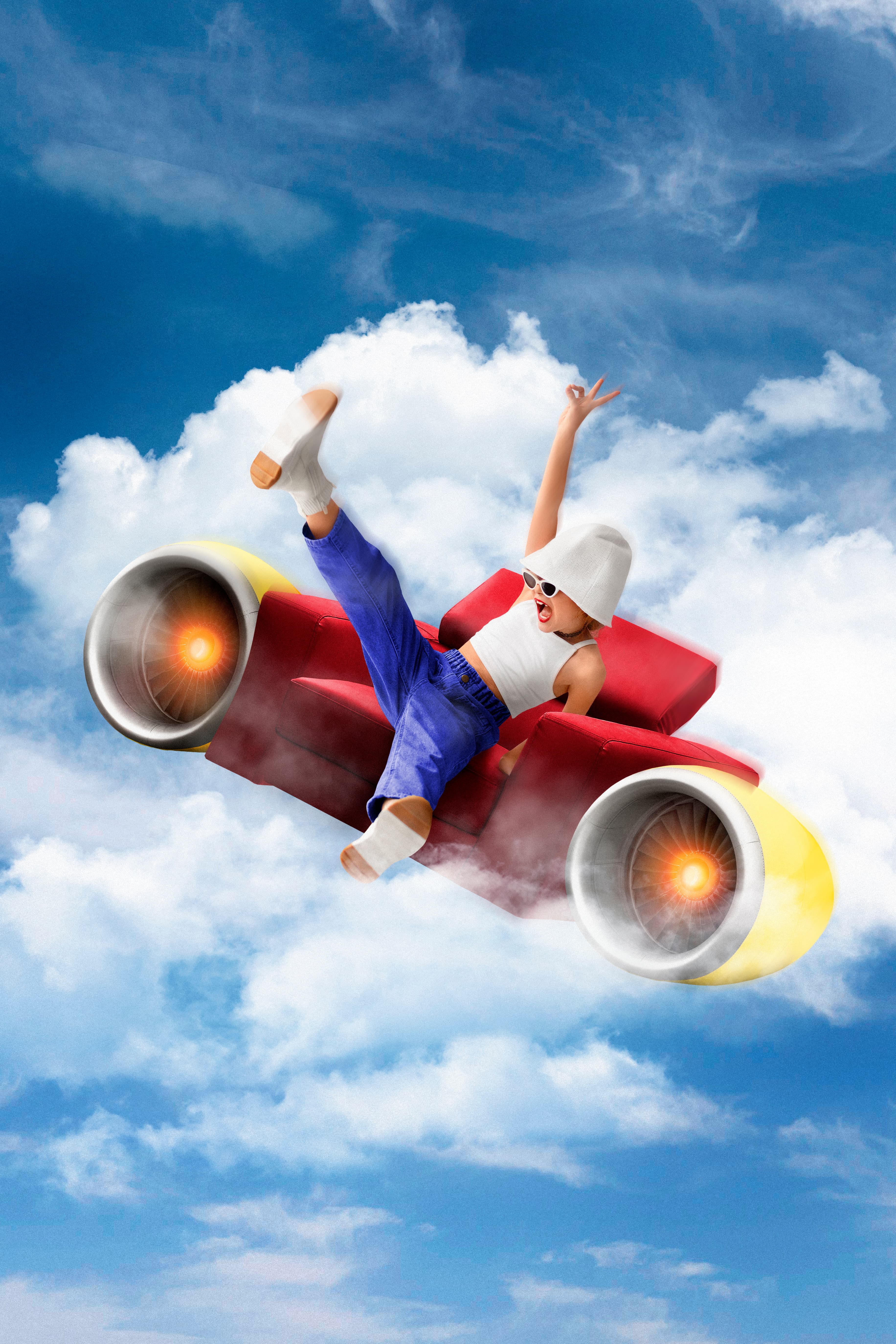 A happy child sitting at a desk and drawing in a journal with crayons.